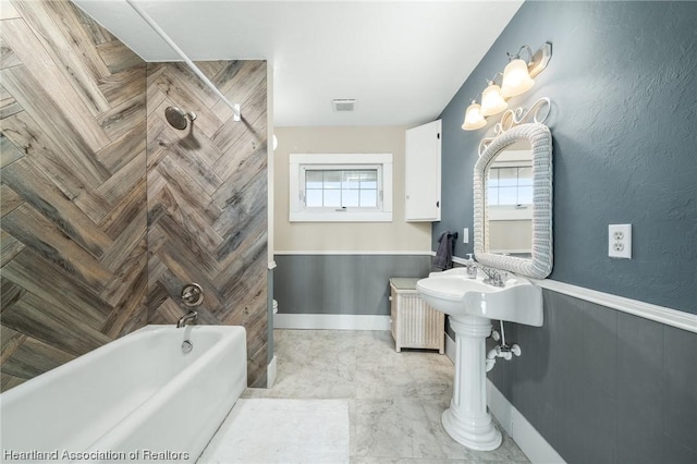 bathroom with bathing tub / shower combination