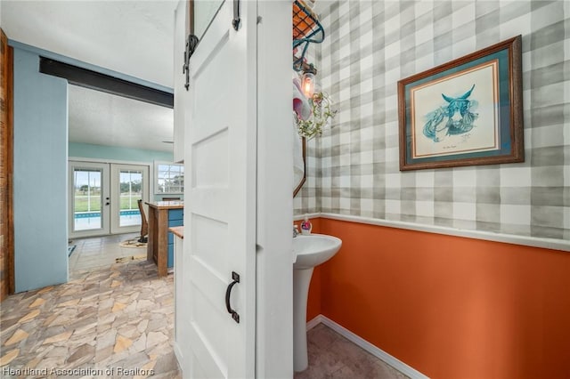 bathroom with french doors and sink