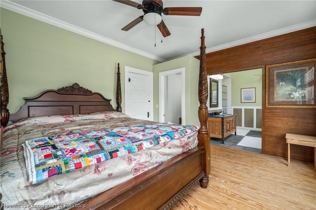 bedroom with ceiling fan, crown molding, and light wood-type flooring