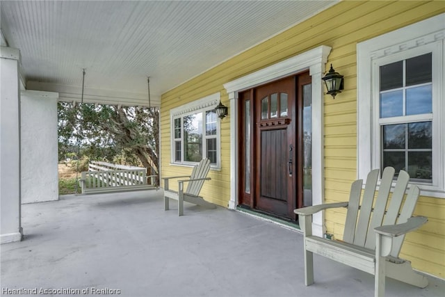 view of exterior entry with a porch