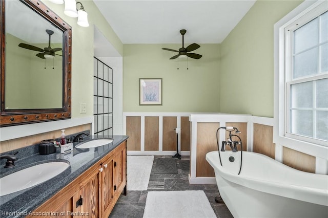 bathroom featuring a washtub, vanity, and ceiling fan