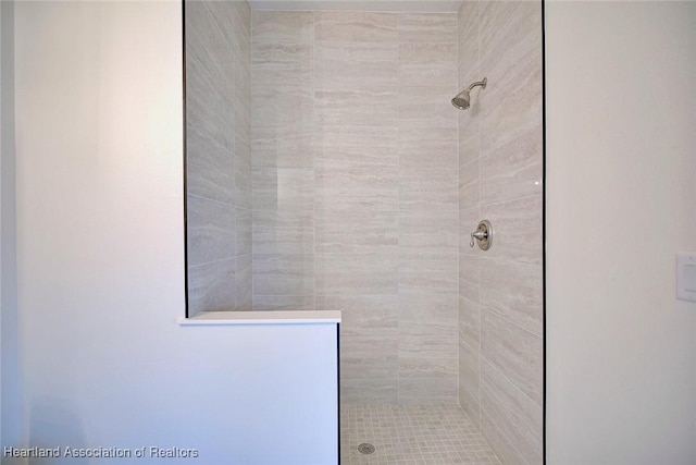 full bath featuring a tile shower