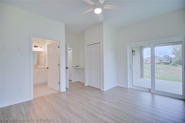 unfurnished bedroom with access to exterior, light wood-style floors, baseboards, and ensuite bathroom