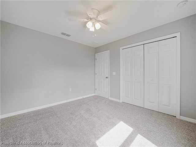 unfurnished bedroom featuring ceiling fan, carpet floors, and a closet