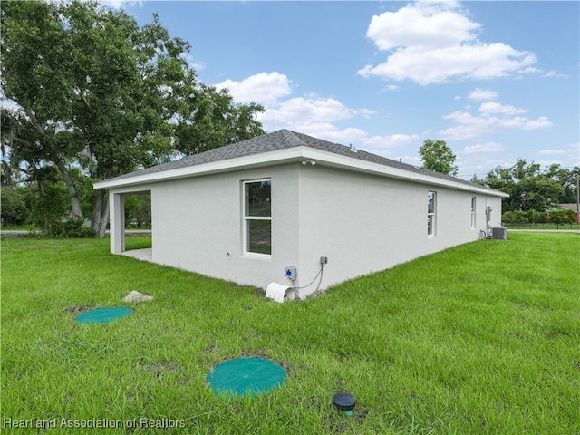 view of home's exterior featuring a lawn and central air condition unit