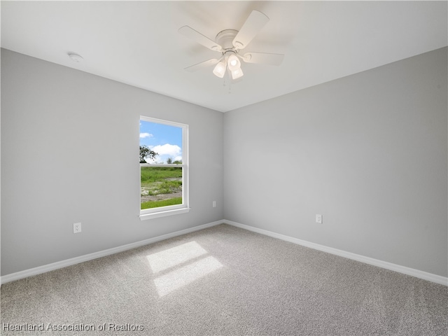 empty room featuring ceiling fan and carpet floors