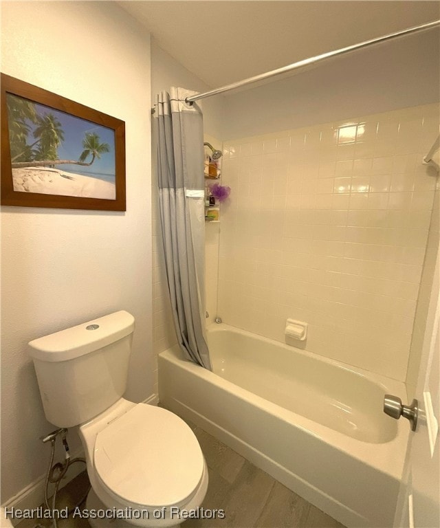 bathroom with shower / tub combo, hardwood / wood-style flooring, and toilet