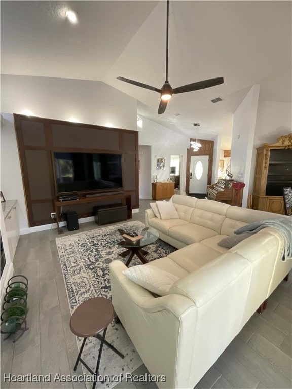 living room with ceiling fan, hardwood / wood-style floors, and lofted ceiling