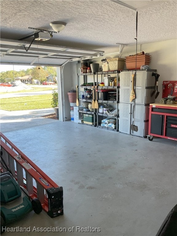 garage featuring refrigerator and a garage door opener