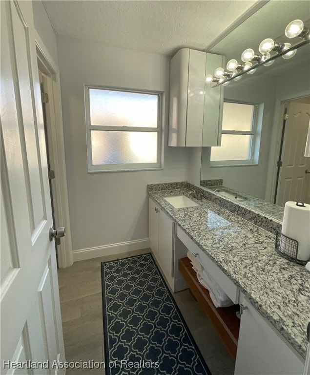 bathroom featuring vanity and a textured ceiling