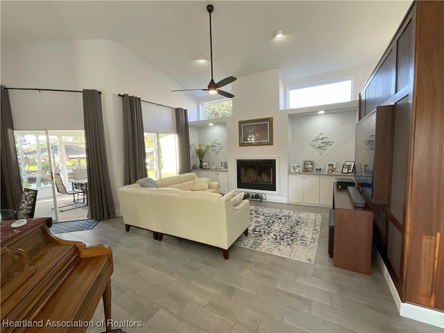 living room with high vaulted ceiling and ceiling fan