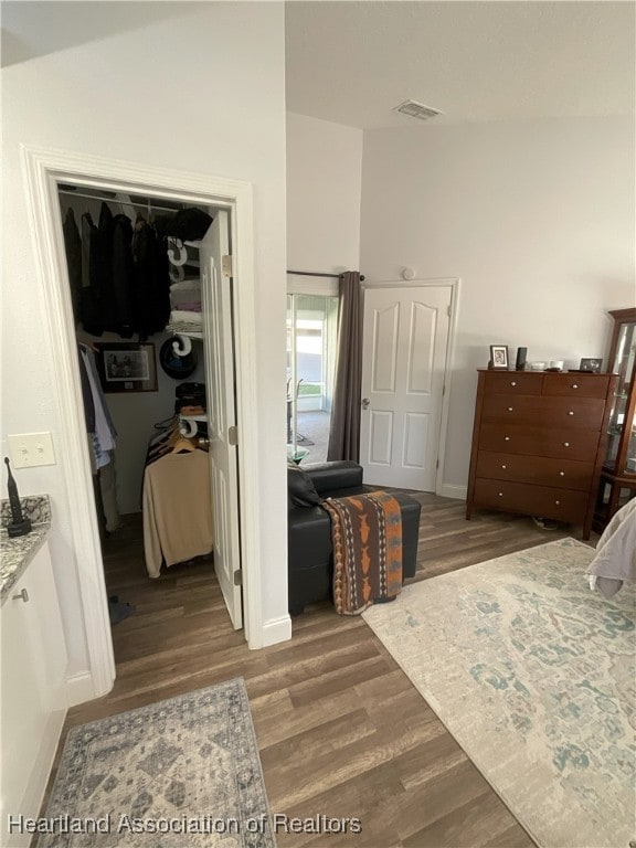 bedroom with a closet and hardwood / wood-style floors