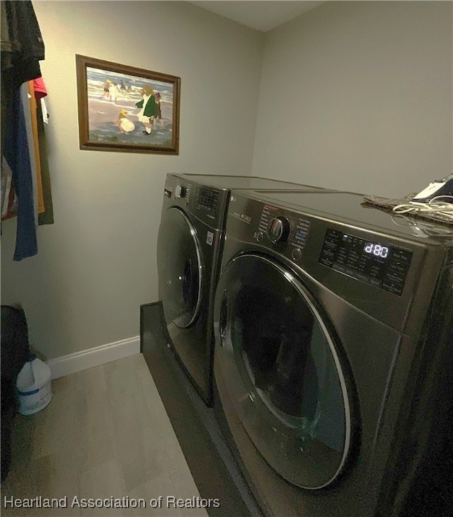 laundry area featuring hardwood / wood-style flooring and independent washer and dryer