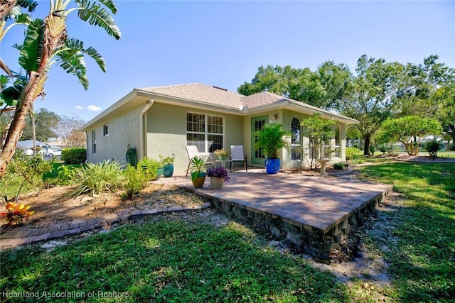 rear view of house with a yard