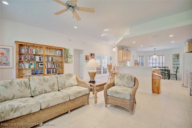 living room with ceiling fan and light tile patterned floors