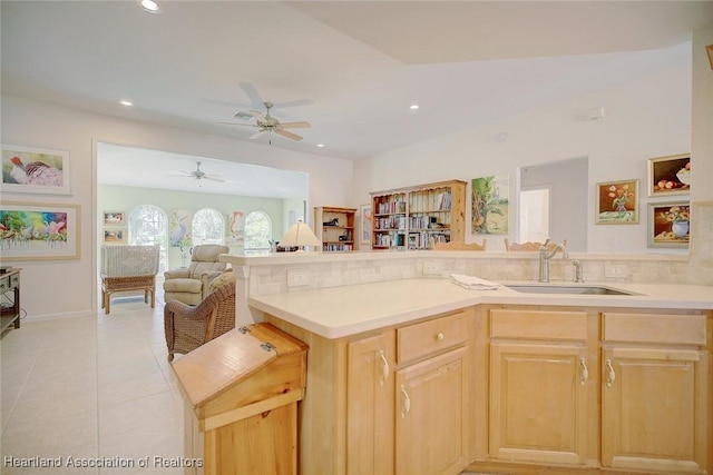 kitchen with light brown cabinetry, ceiling fan, sink, and light tile patterned flooring