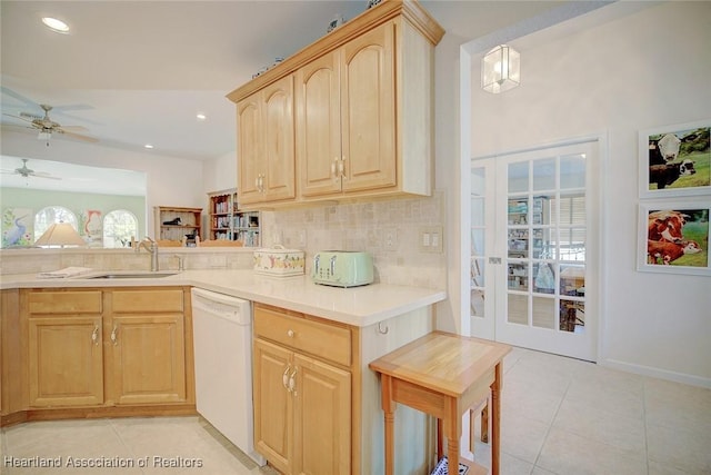 kitchen featuring ceiling fan, sink, light brown cabinets, hanging light fixtures, and white dishwasher