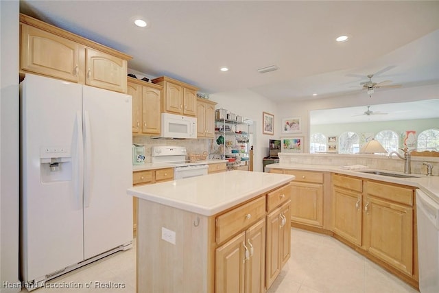 kitchen featuring white appliances, ceiling fan, sink, light brown cabinets, and a center island