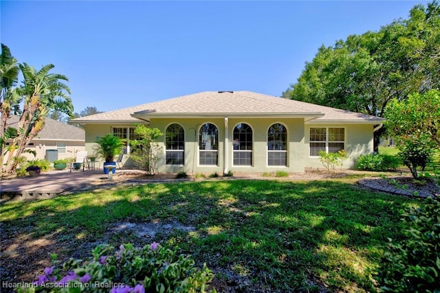 view of front of home with a patio area and a front yard