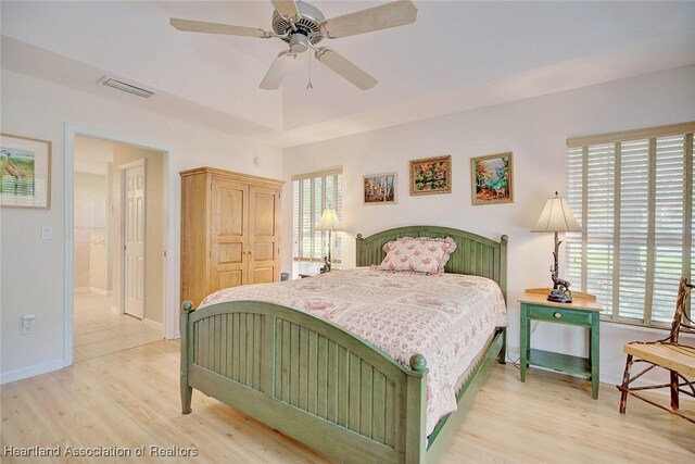 bedroom featuring ceiling fan, light hardwood / wood-style flooring, and a closet