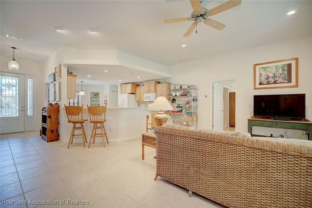 tiled living room featuring ceiling fan