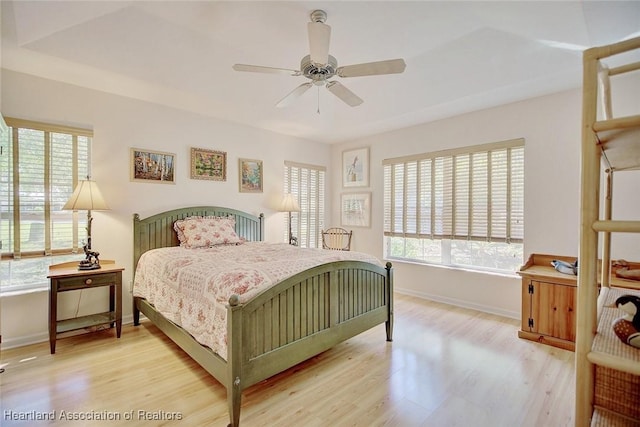 bedroom with light hardwood / wood-style flooring and ceiling fan