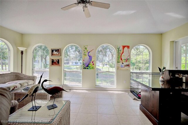 living room with ceiling fan and light tile patterned floors