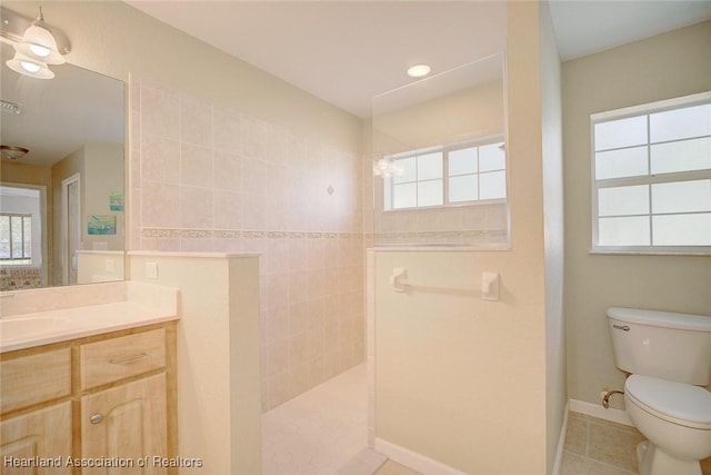 bathroom with a shower, vanity, toilet, and tile patterned flooring