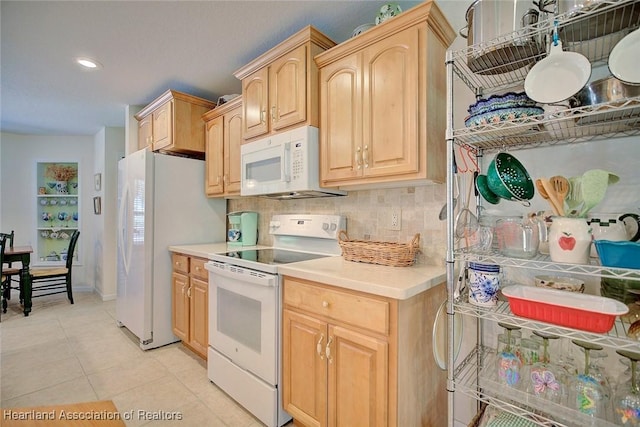 kitchen with decorative backsplash, light brown cabinetry, light tile patterned flooring, and white appliances