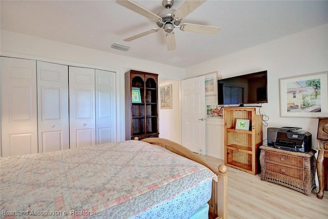 bedroom with ceiling fan, a closet, and light hardwood / wood-style flooring