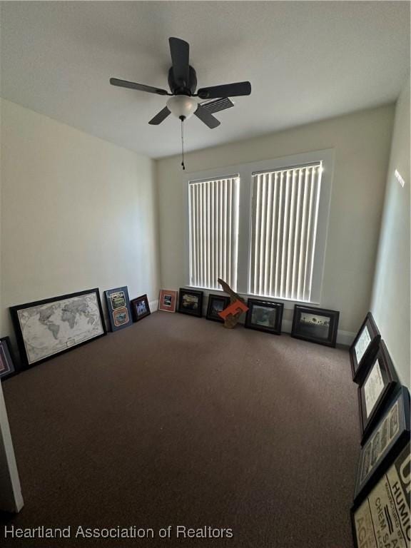 interior space with ceiling fan