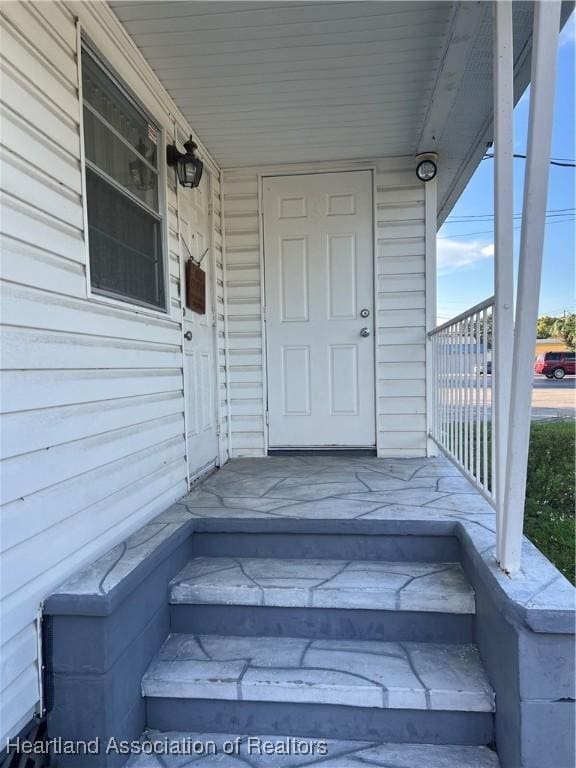 view of exterior entry with a porch