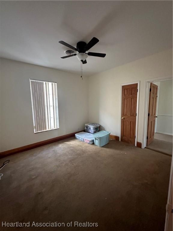 unfurnished bedroom with carpet flooring and ceiling fan