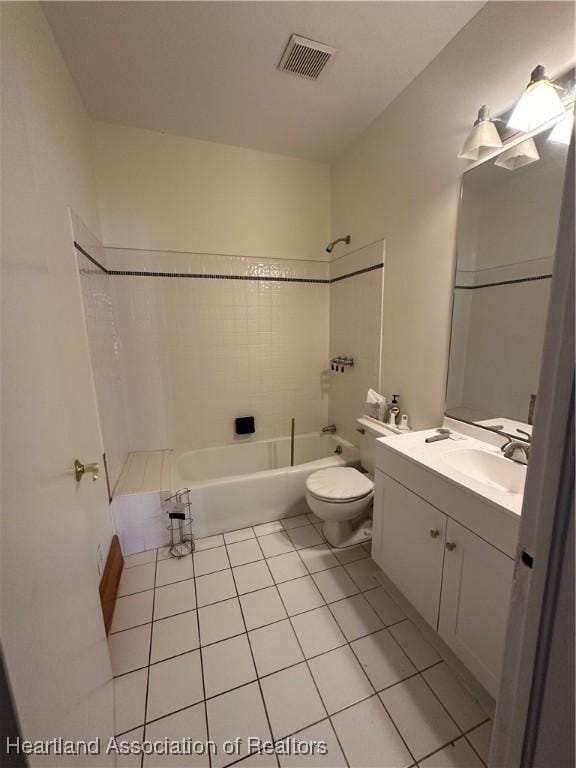 full bathroom featuring tile patterned floors, vanity, toilet, and tiled shower / bath