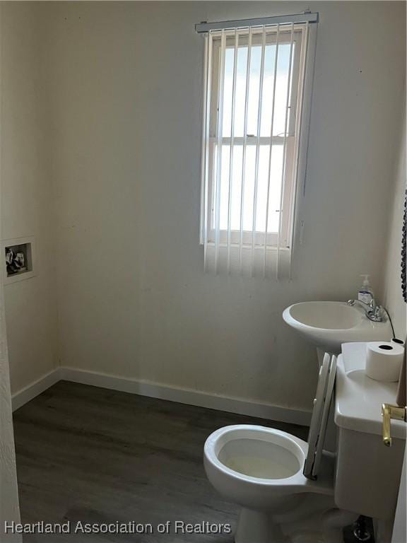 bathroom with hardwood / wood-style floors and toilet