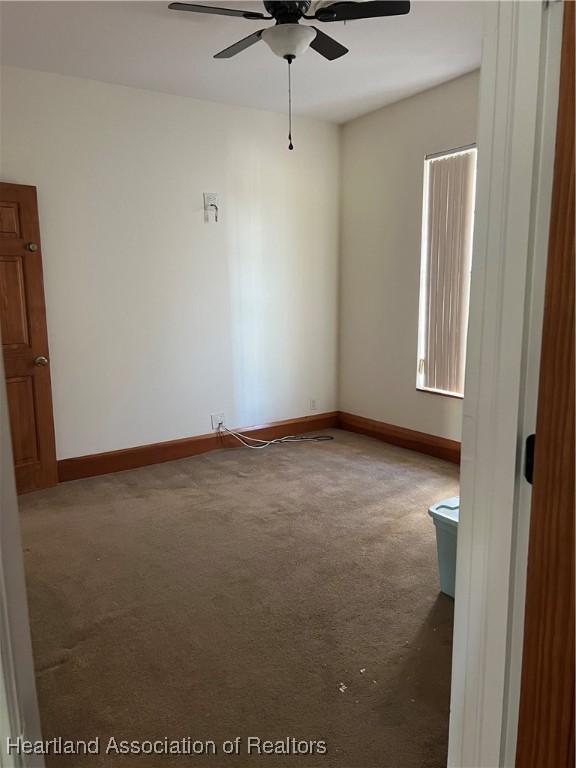 unfurnished room with carpet floors and ceiling fan