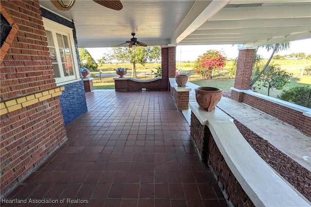 view of patio with ceiling fan and a porch