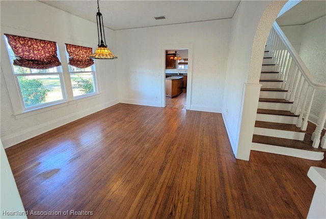 unfurnished dining area with dark hardwood / wood-style floors