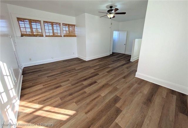 unfurnished room with ceiling fan and dark wood-type flooring