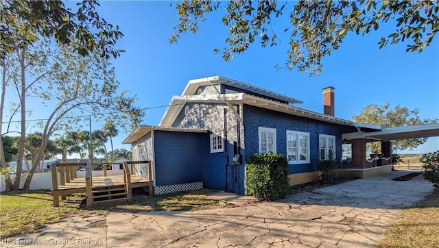 view of home's exterior featuring a wooden deck