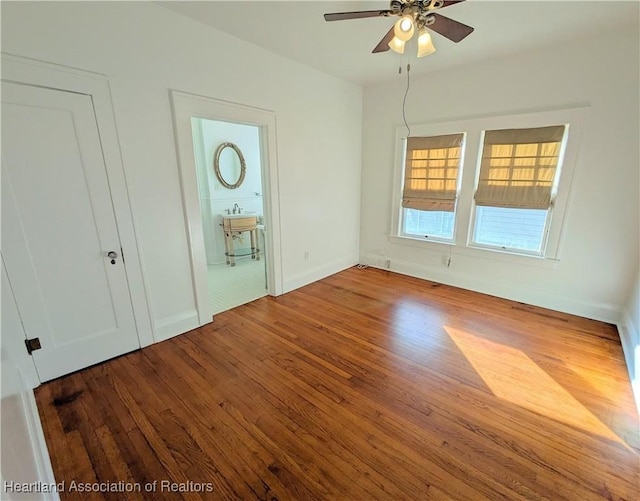 empty room with wood-type flooring and ceiling fan