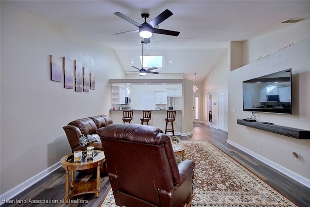 2112 Coral Ct, Sebring, FL 33870 - living room featuring ceiling fan, lofted ceiling, dark wood-style floors, and baseboards