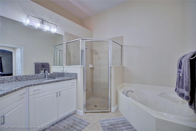 2112 Coral Ct, Sebring, FL 33870 - full bathroom with vanity, a bath, a stall shower, and tile patterned flooring