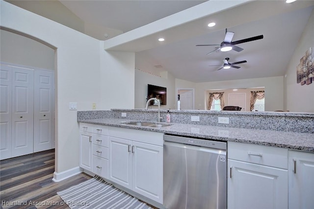 2112 Coral Ct, Sebring, FL 33870 - kitchen with stainless steel dishwasher, a sink, light wood-style flooring, light stone countertops, and vaulted ceiling