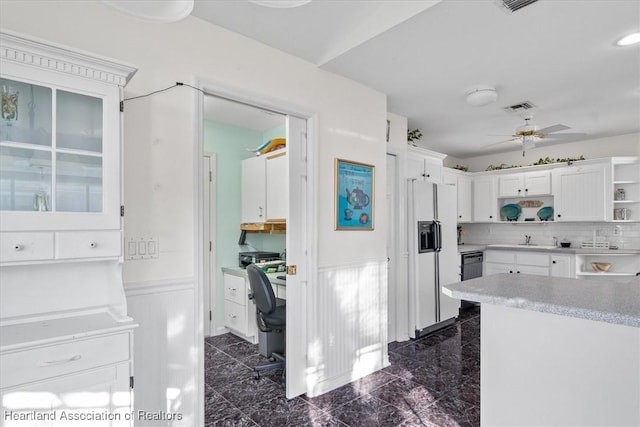 kitchen with ceiling fan, white cabinets, white fridge with ice dispenser, and tasteful backsplash