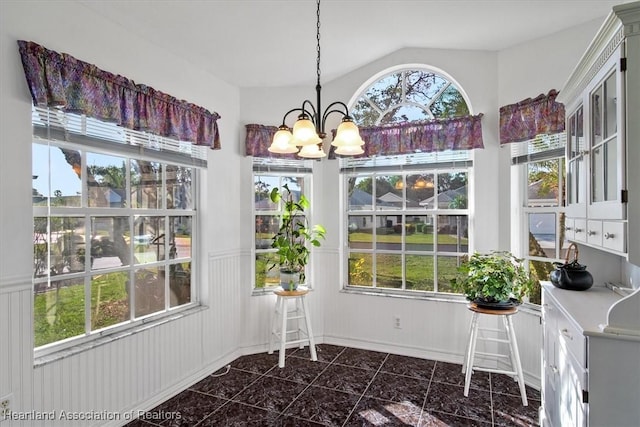 unfurnished sunroom with vaulted ceiling and an inviting chandelier