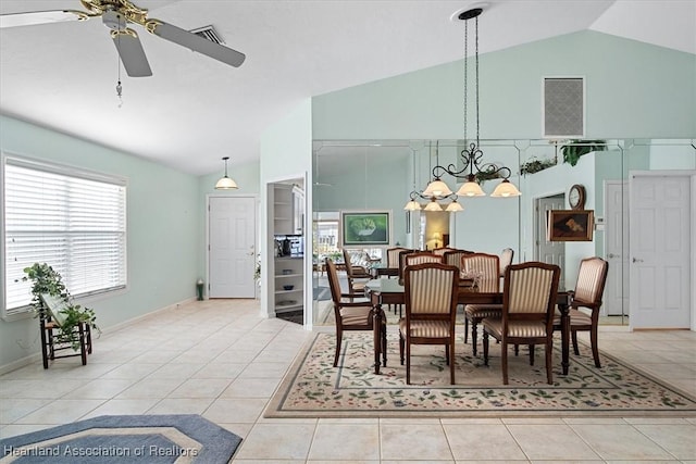 tiled dining space featuring ceiling fan and vaulted ceiling