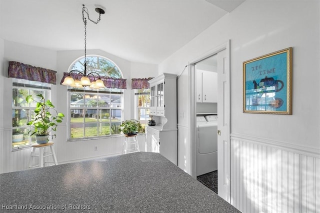 unfurnished dining area with lofted ceiling and an inviting chandelier