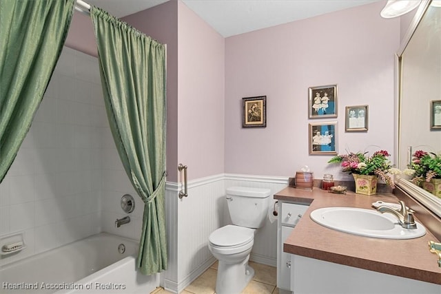 full bathroom featuring toilet, tile patterned flooring, vanity, and shower / bath combo with shower curtain