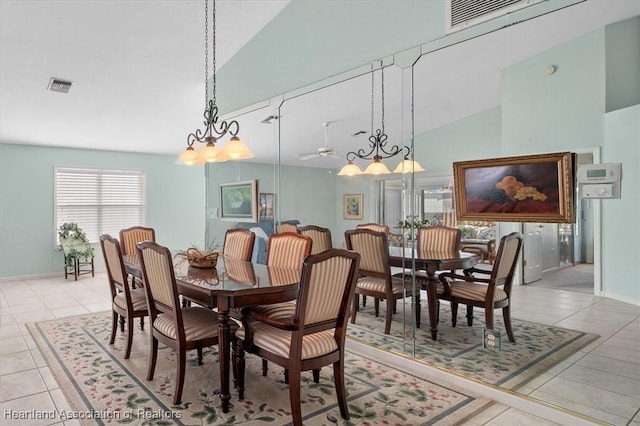 dining room featuring ceiling fan, light tile patterned floors, and high vaulted ceiling